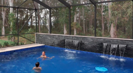 kids swimming in a screen pool enclosure